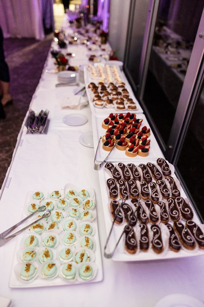 Dessert table for Lincolnshire Marriott Resort wedding reception features assorted pastries, including eclairs, fruit tarts, and decorated cookies