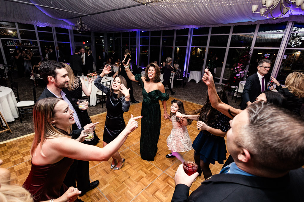 Guests dressed formally are dancing and celebrating together on the dance floor during wedding reception at Lincolnshire Marriott Resort