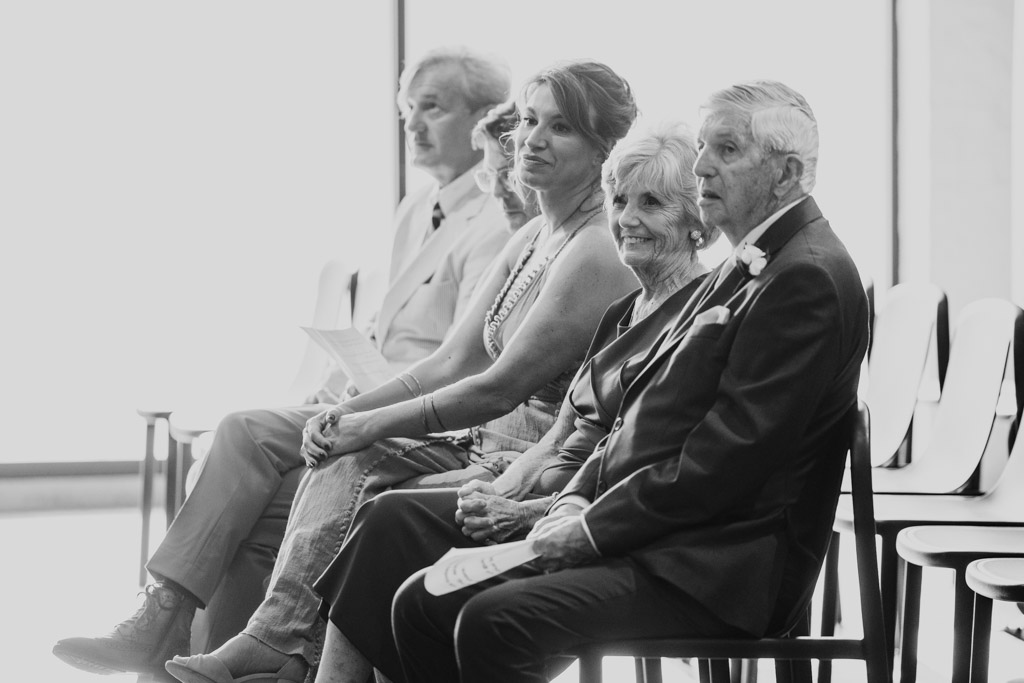 Black and white photo of groom's family seated during summer wedding reception at Sarabande Chicago