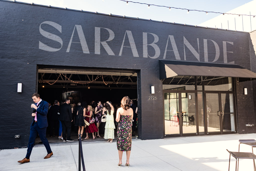 Guests gather outside Sarabande Chicago before summer wedding celebration
