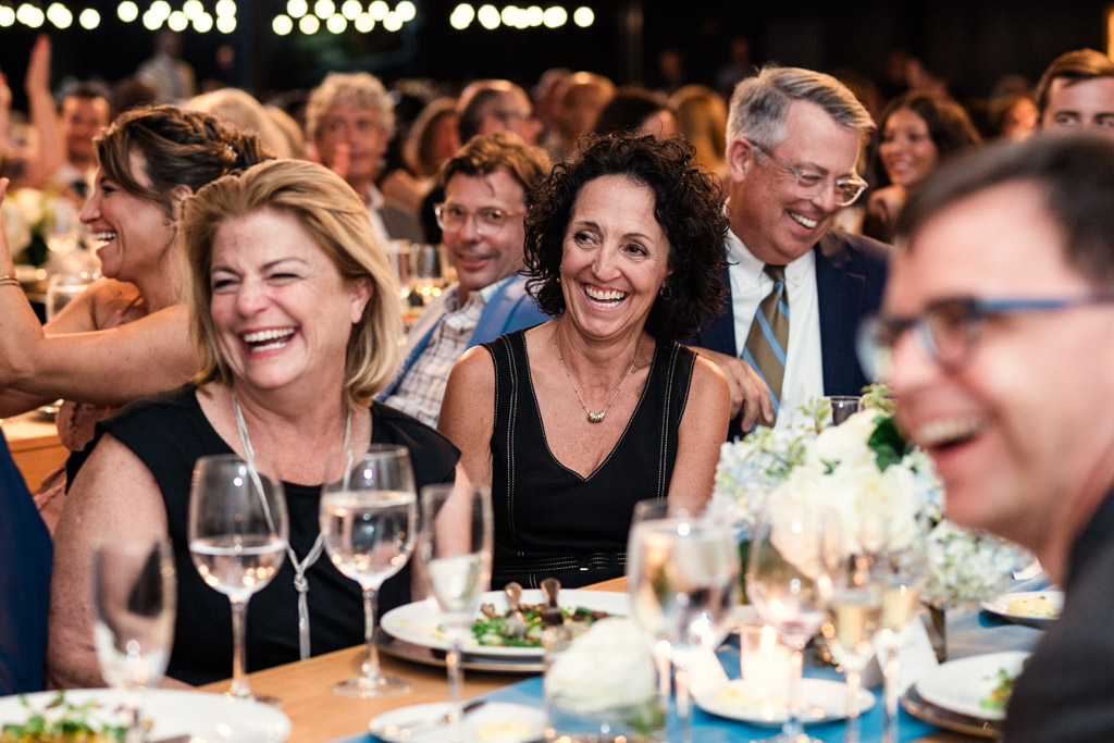 Guests in formal attire laughing and smiling during summer wedding reception at Sarabande Chicago