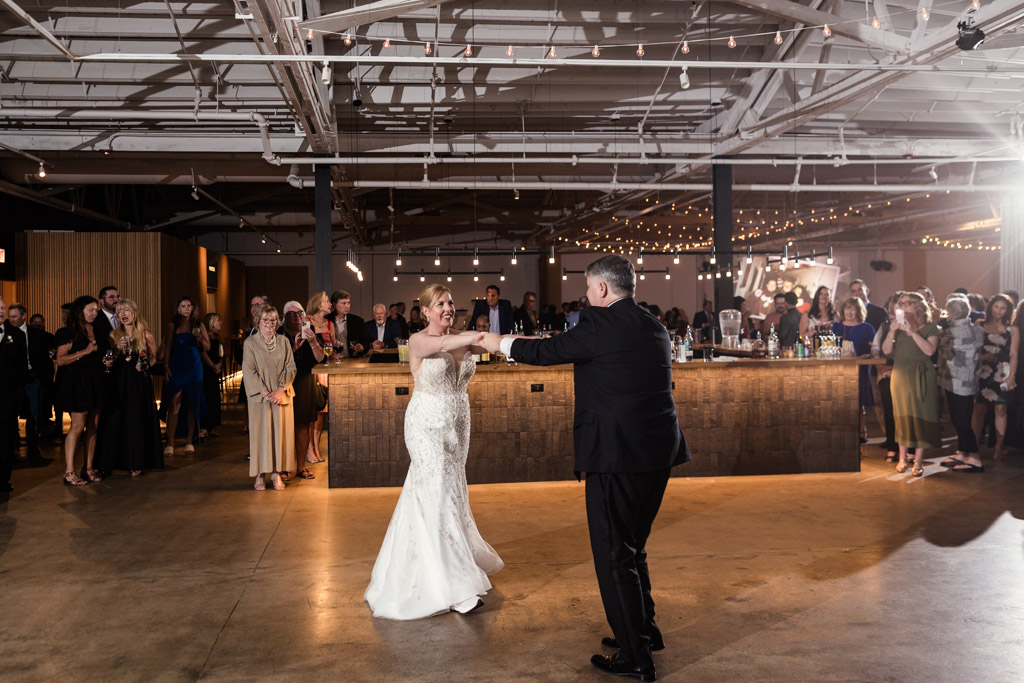 Bride and groom during their first dance as guests watch at Sarabande Chicago