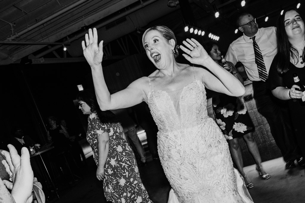 A joyful bride in a wedding dress on the dance floor during her Sarabande Chicago wedding reception