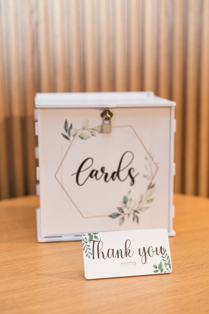 A white card box sits on a wooden table for wedding celebration at Sarabande Chicago