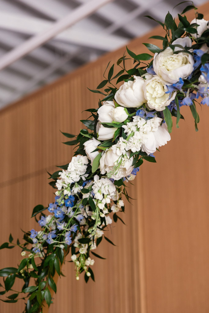 Detail photo of floral arch with white and blue flowers and green leaves for Sarabande Chicago wedding ceremony