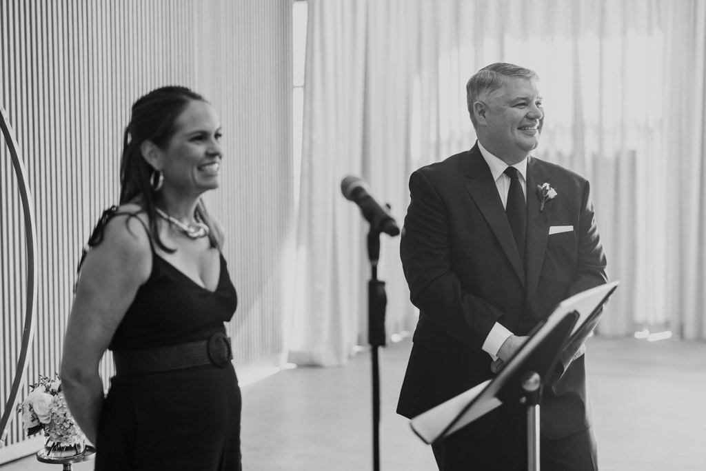 Black and white photo of groom and officiant watching bride walk down the aisle during Sarabande Chicago wedding ceremony