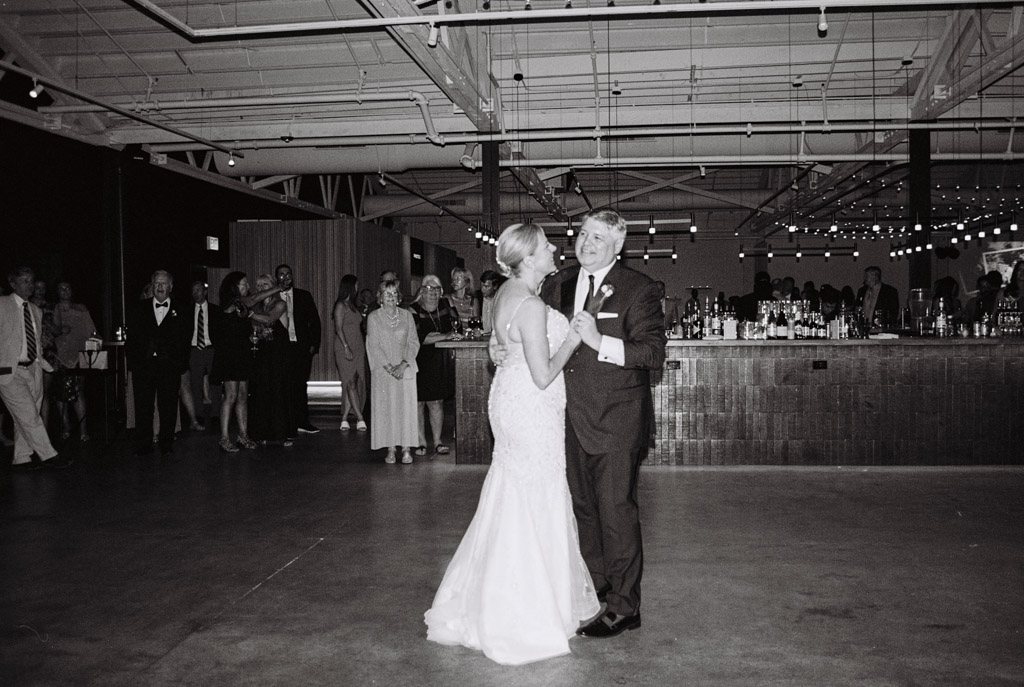 Bride and groom share their first dance with guests watching during their Sarabande Chicago wedding reception