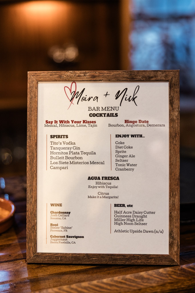 Framed bar menu for Salvage One wedding reception, featuring custom cocktail options, spirits, mixers, and wines