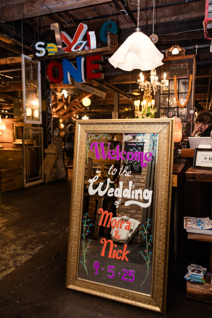 Painted mirror welcome sign with golden frame for Salvage One wedding celebration