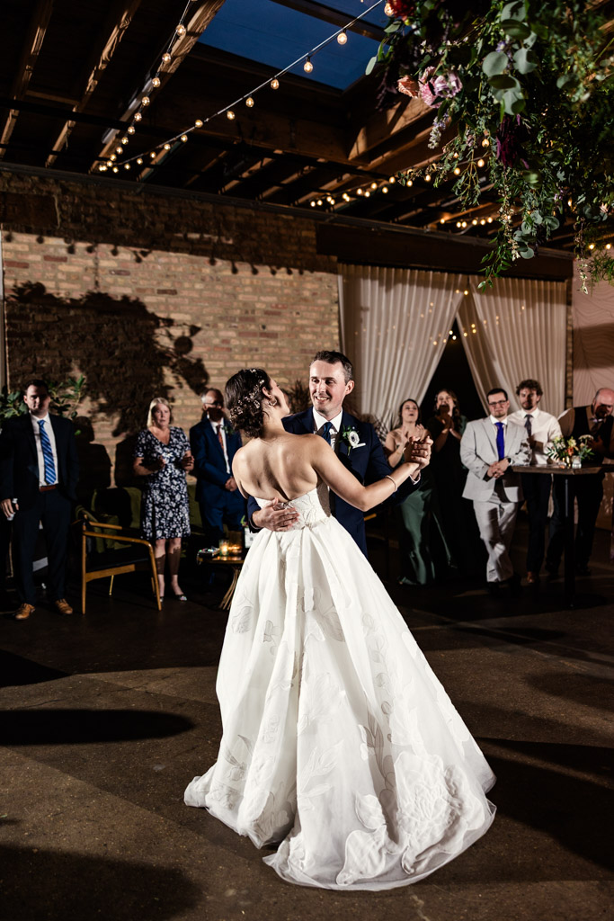 Bride and groom during their first dance at their Arbory Chicago wedding reception, surrounded by guests