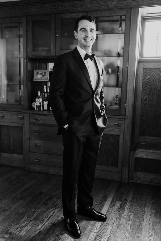Black and white portrait of groom in a tuxedo before his wedding celebration at The Joinery in Chicago