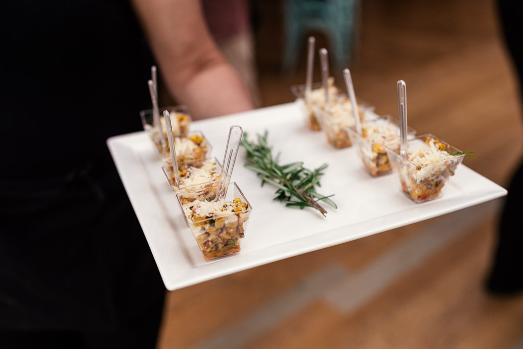 Tray of small appetizer cups with forks and a garnish of rosemary for wedding reception at The Joinery in Chicago