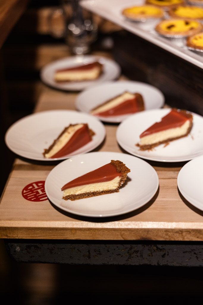 Slices of cheesecake on white plates, arranged on a wooden table for wedding reception at The Joinery
