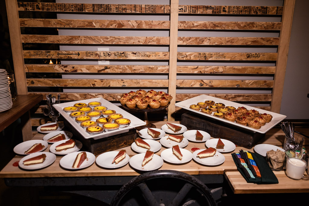 Dessert table with plates of cheesecake slices and trays of tarts for wedding reception at The Joinery in Chicago