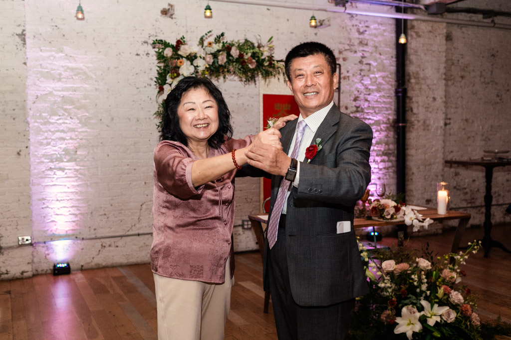 Bride's parents in formal attire dance together during wedding reception at The Joinery in Chicago
