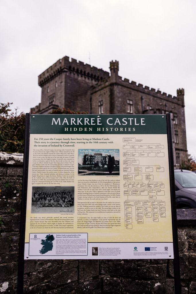Information sign about Markree Castle with the castle building visible in the background under a cloudy sky