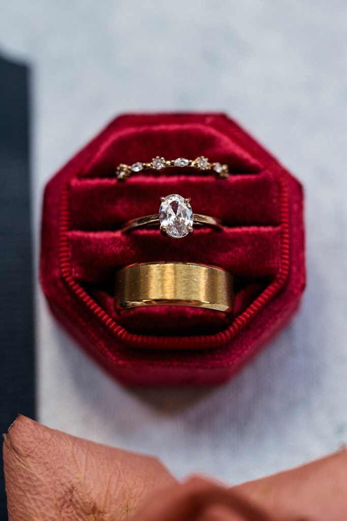 Three gold rings, including a diamond ring, in a red velvet ring box for Markree Castle wedding celebration