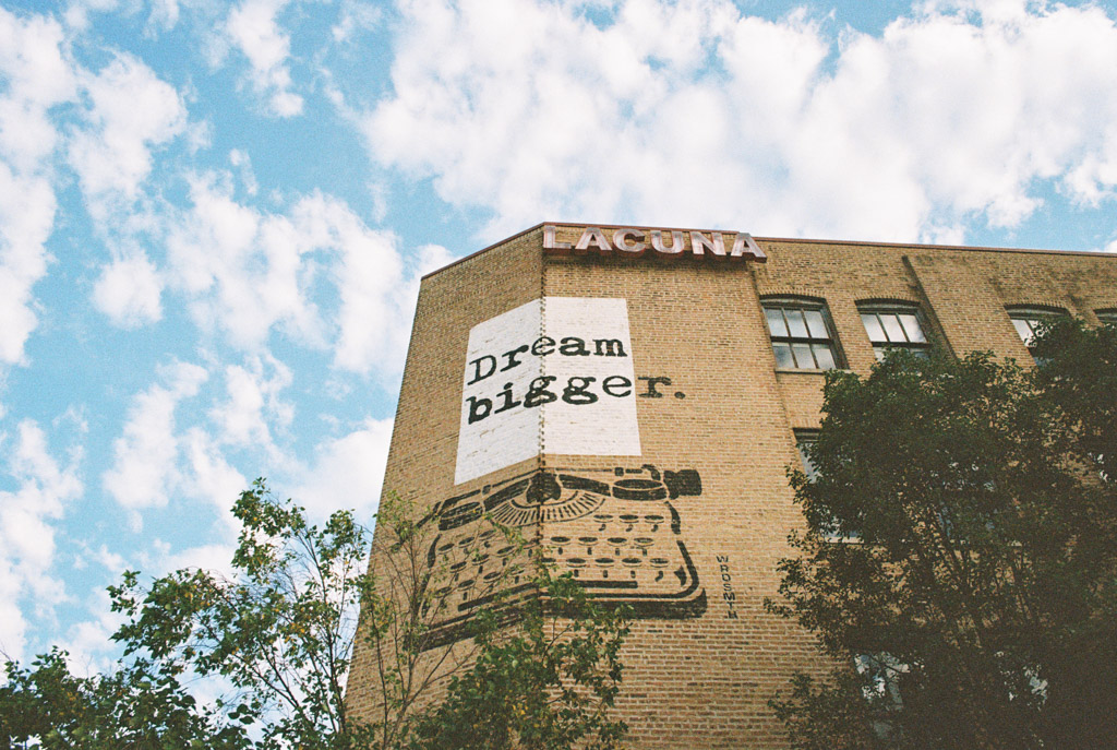 Film photo of Lacuna Lofts exterior with a mural of a typewriter and the words 
