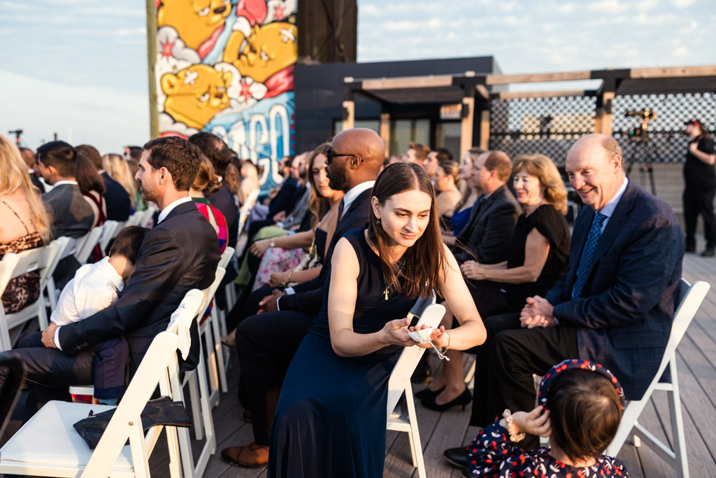 Guests shows the couple's rings to a small child during ring-warming ceremony at Lacuna Lofts