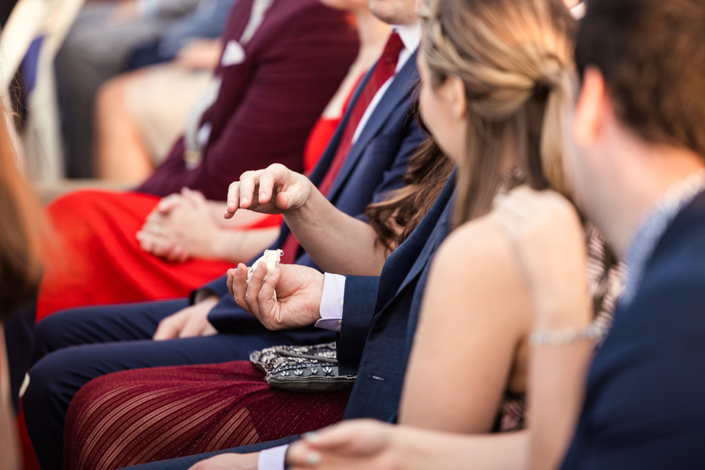 guests passing around the couple's rings during ring-warming ceremony at Lacuna Lofts