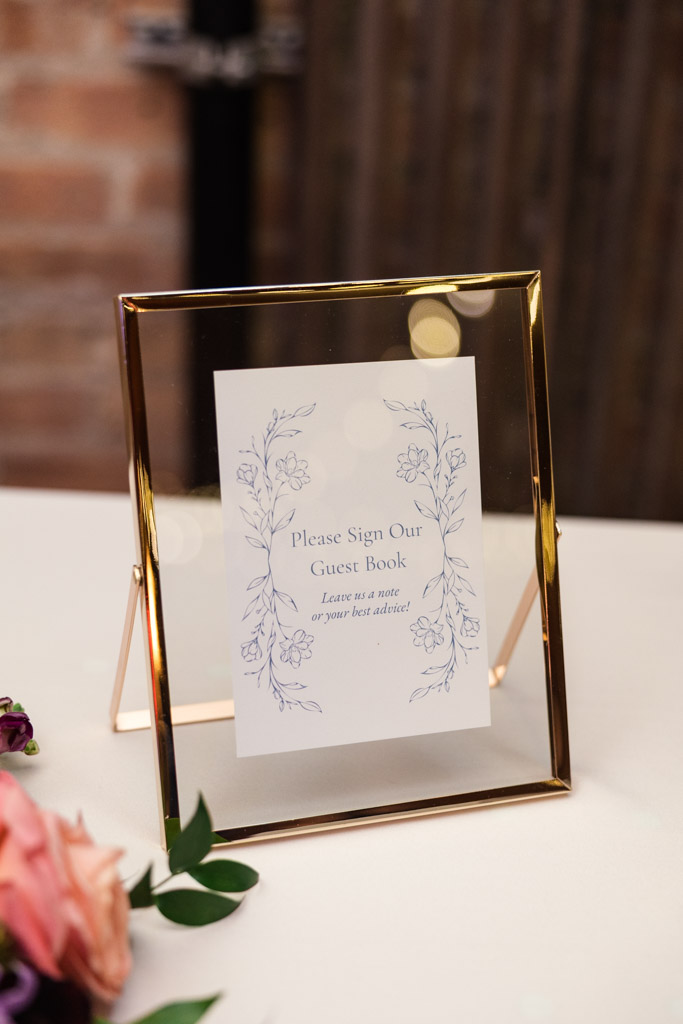 Framed guest book sign on a table for wedding reception at Lacuna Lofts