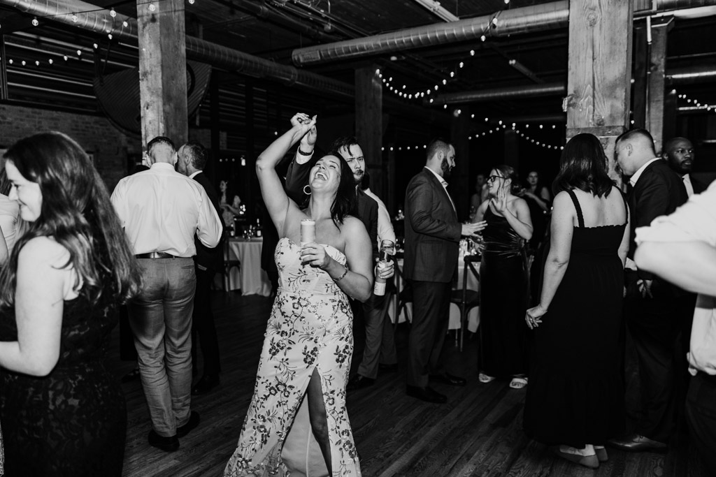 Black and white photo of guests dancing during wedding reception at Lacuna Lofts