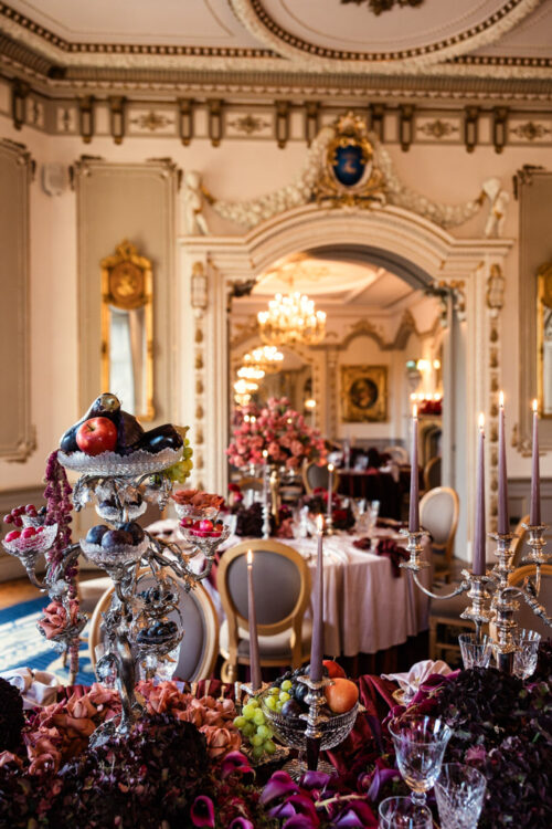 Elegant dining room with ornate decor, lavish table settings, fruit centerpiece, and floral arrangements—perfect for a Markree Castle wedding.