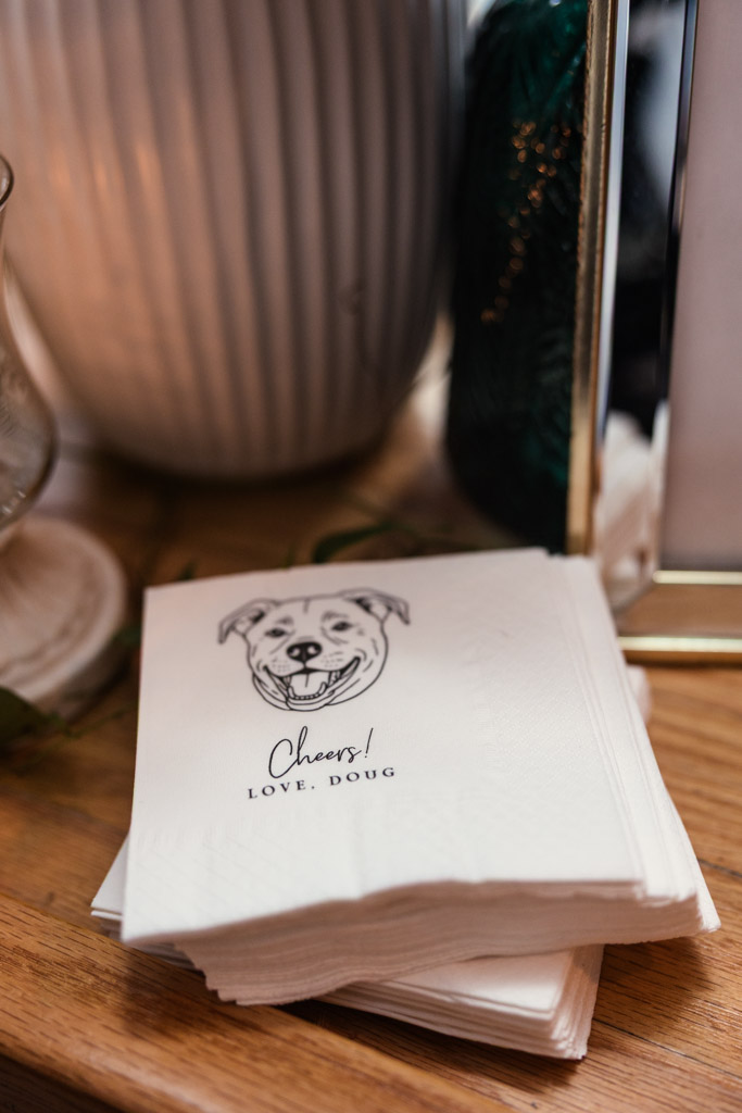 A stack of custom napkins with a smiling dog illustration and the words 