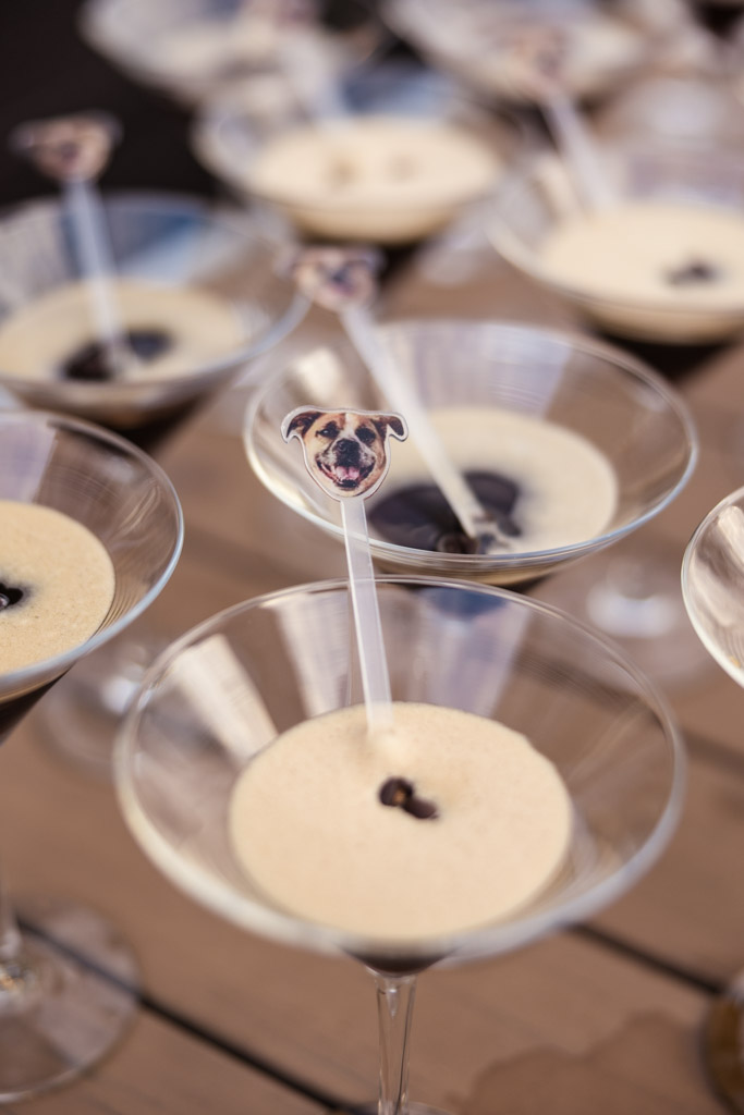 Custom cocktails, each with a stir stick topped by a dog’s face cutout for Bottom Lounge wedding celebration