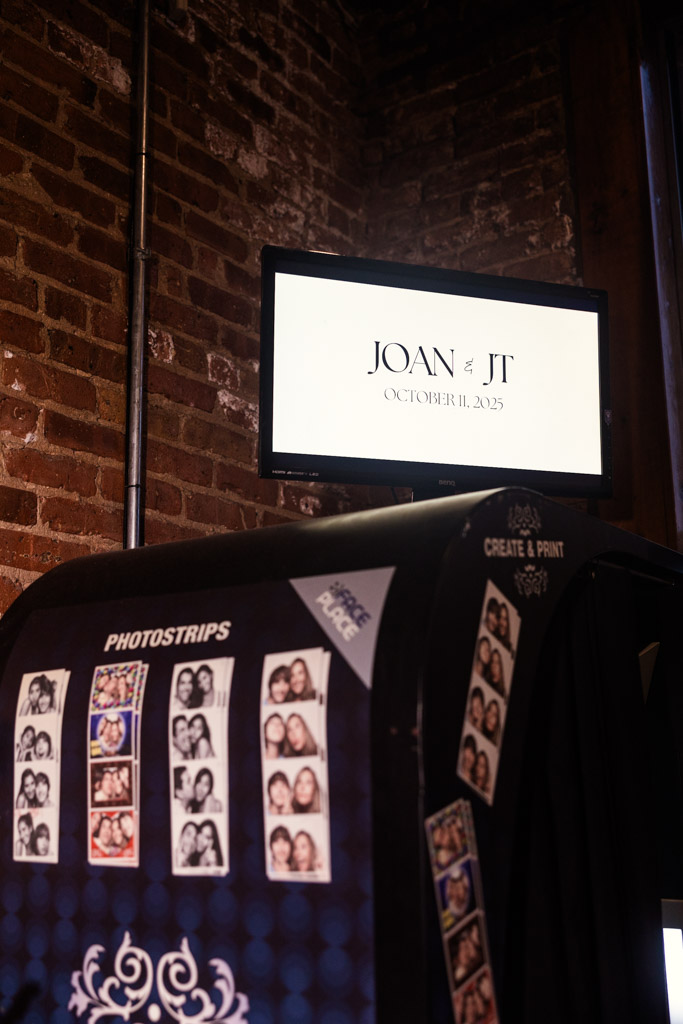 A photo booth with photostrips and a screen for Bottom Lounge wedding reception
