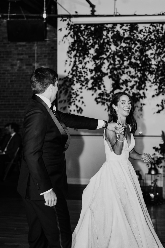 Black and white photo of bride and groom during their first dance at their Bottom Lounge wedding reception