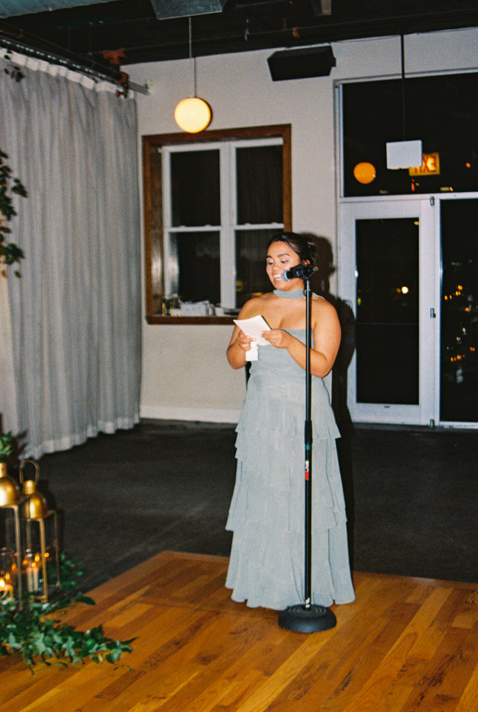 Maid of Honor speaks into a microphone, during Bottom Lounge wedding reception