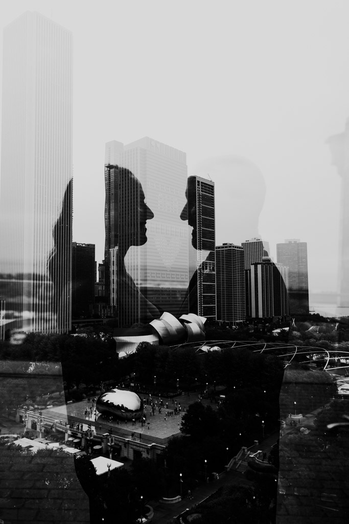Creative black and white double exposure photo of silhouettes of bride and groom facing each other, superimposed over a Chicago cityscape with tall buildings