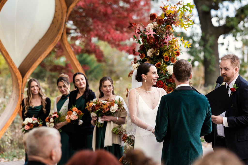 A bride and groom listen as the officiant speaks during their wedding ceremony at the Lincoln Park Honeycomb
