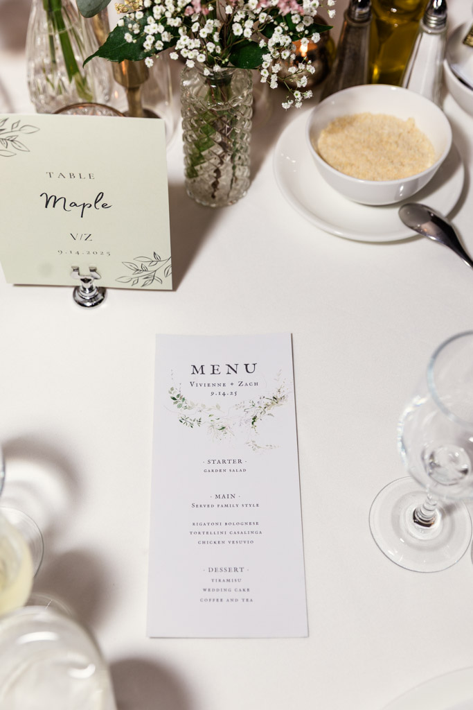 Wedding table setting at Salvatore's with a floral themed menu, table card and fresh flowers