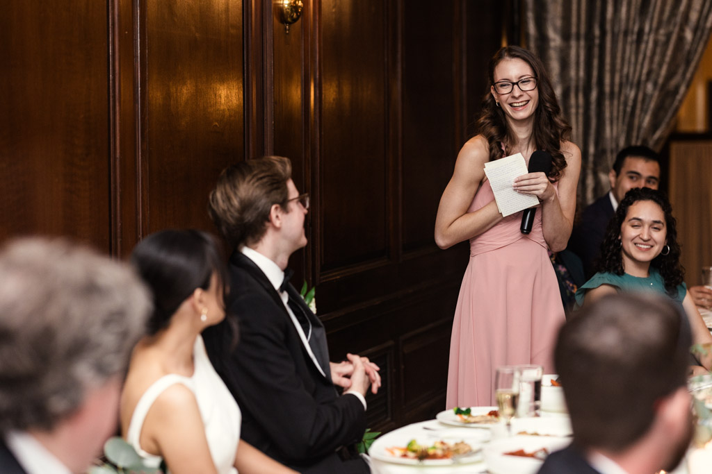 Maid of Honor in a pink dress gives a speech during wedding reception at Salvatore's