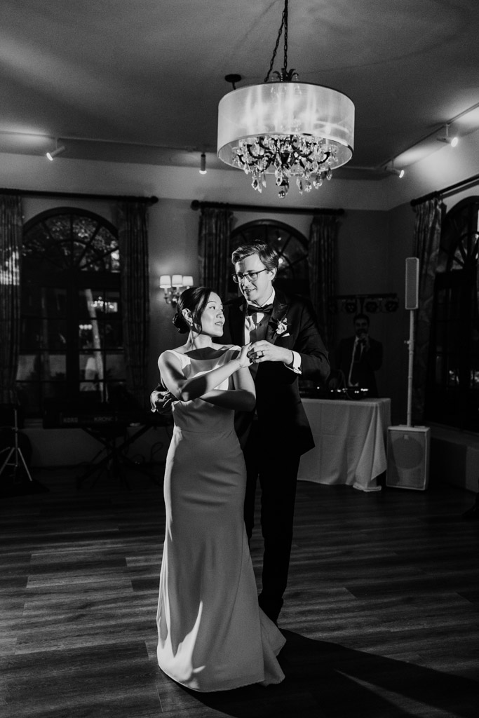 Black and white photo of bride and groom during their first dance in the reception hall at Salvatore's