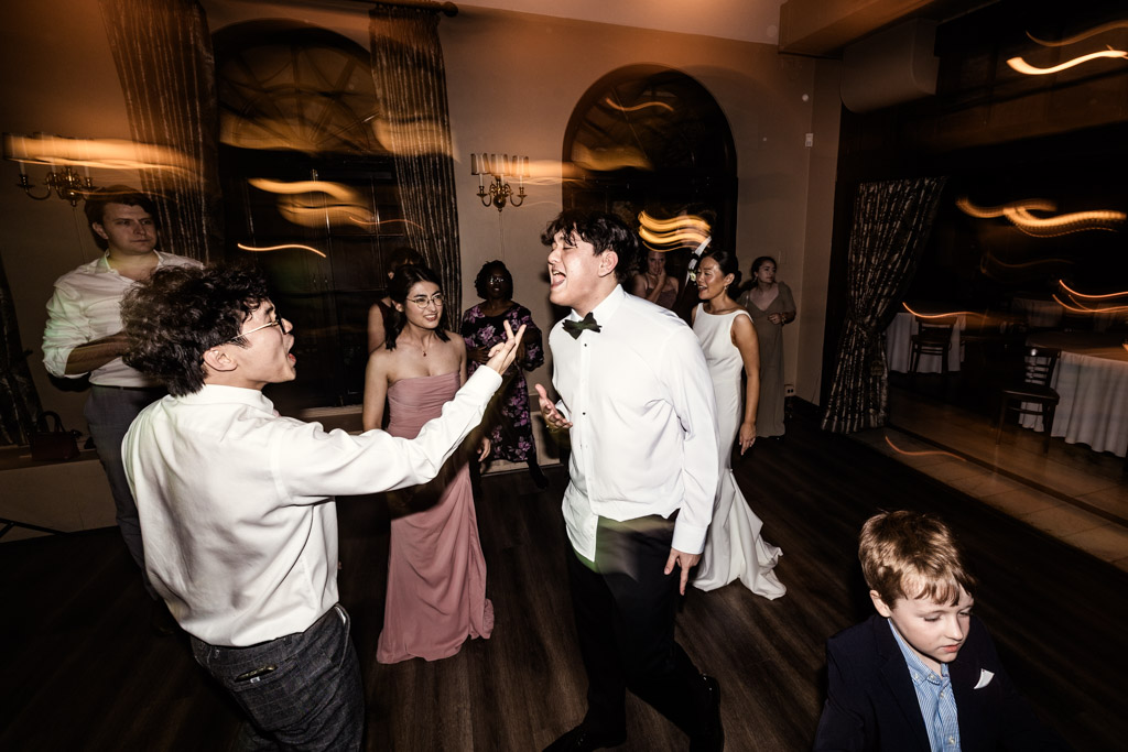 Guests dancing and singing during wedding reception at Salvatore's