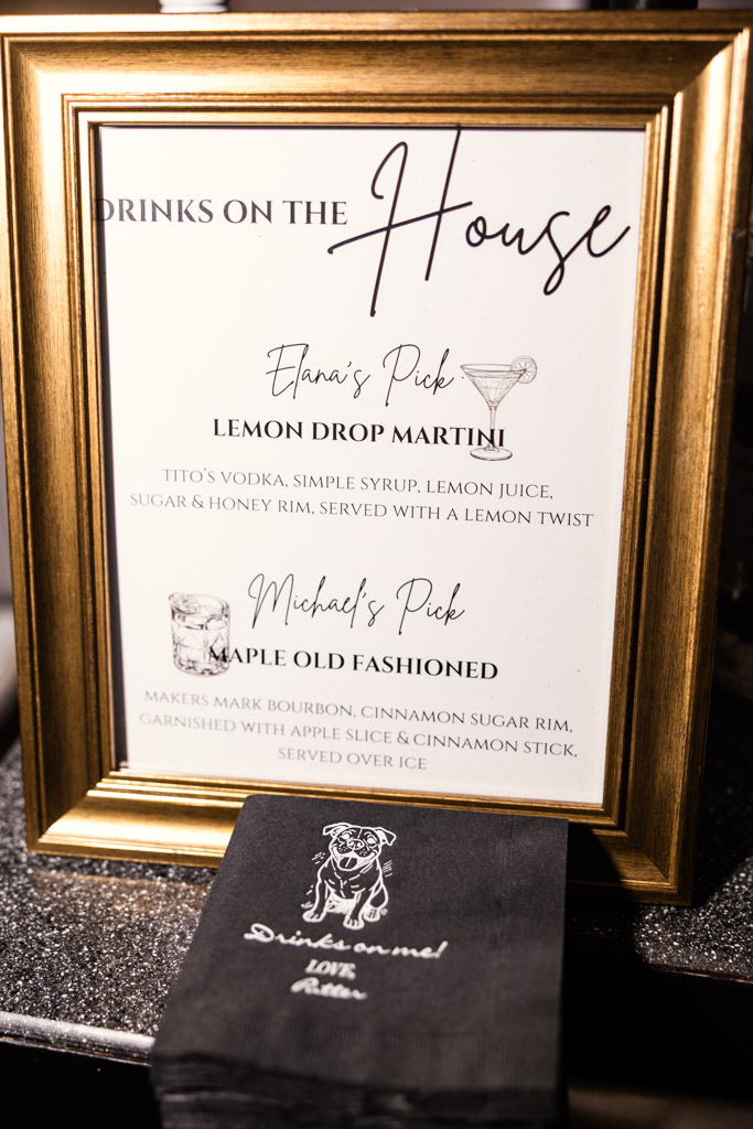Framed bar menu with drink options and custom black napkin printed with a dog illustration for Four Seasons Chicago wedding reception