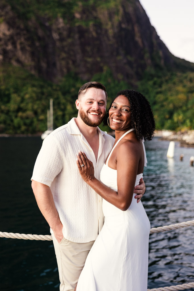 Portrait of happy newlywed couple by the water at Viceroy Sugar Beach, with Petit Piton in the background