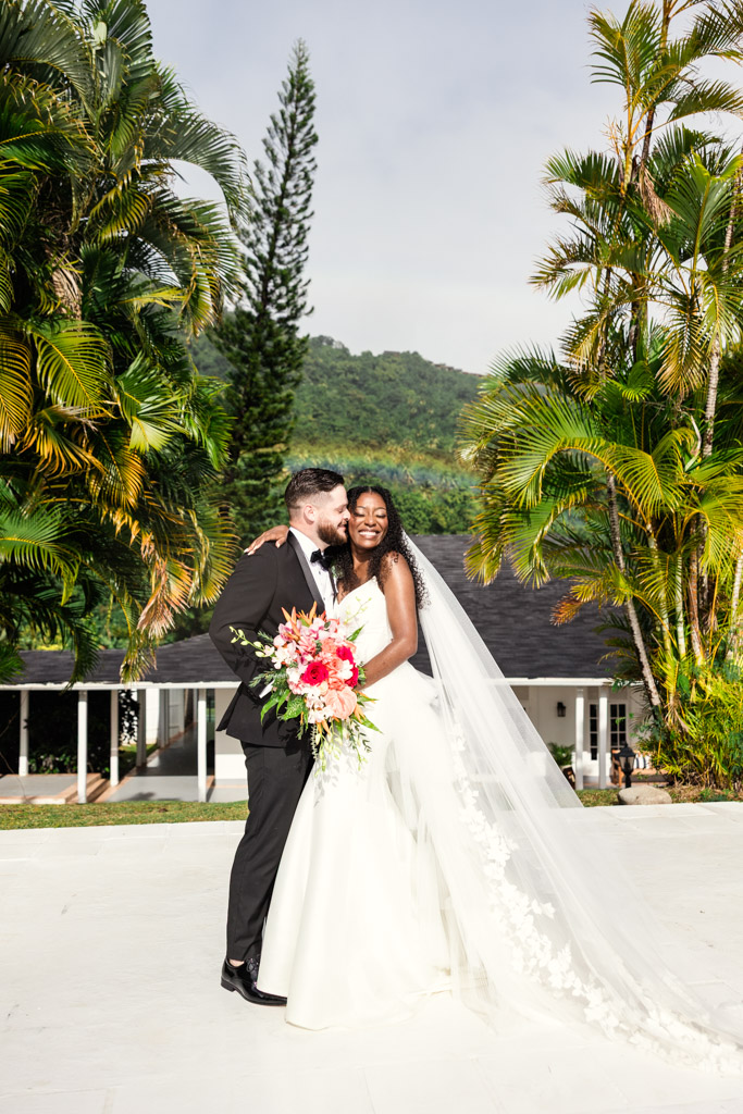 Happy bride and groom embrace on the Sunset Deck at Viceroy Sugar Beach