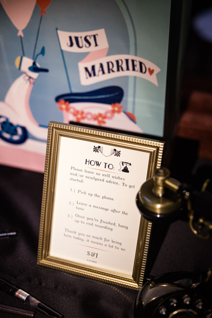 Framed wedding instructions beside a vintage phone, with a 