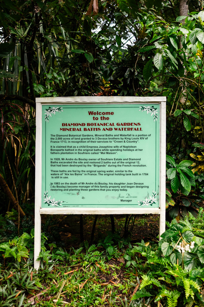Sign at Diamond Falls Botanical Gardens describes its history, mineral baths, and founder