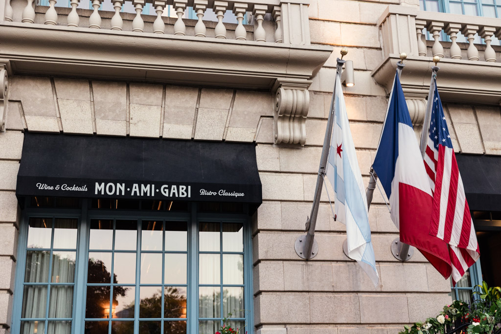 Awning of Mon Ami Gabi restaurant with Chicago, French, and U.S. flags at The Belden-Stratford in Chicago