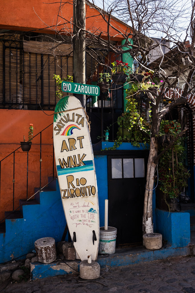 A painted surfboard sign for the 