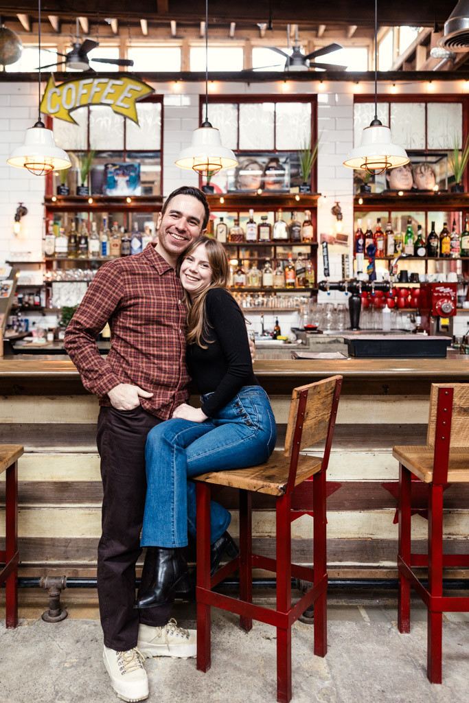 Portrait of happy engaged couple at a bar inside Kibbitznest in Chicago