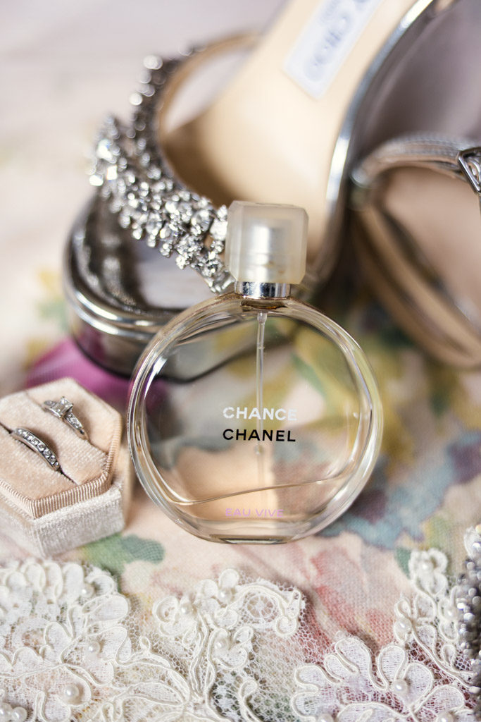 Bride's Chanel Chance Eau Vive perfume bottle with silver heels, veil and jewelry for Terra Mia Vineyard wedding celebration