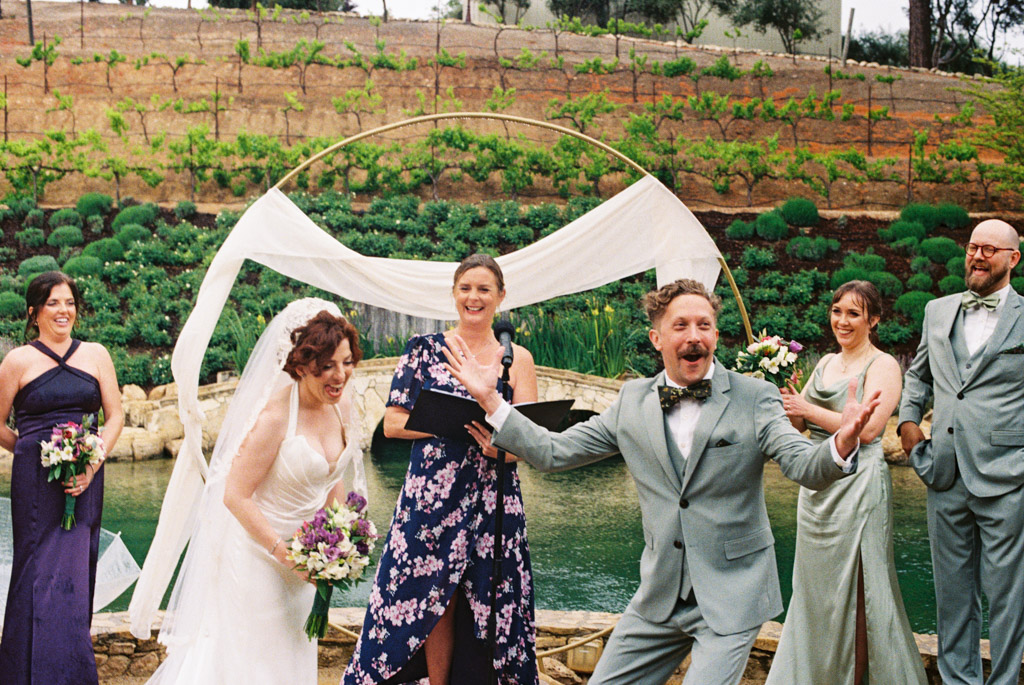 Film photo of bride and groom laughing during their wedding ceremony at Terra Mia Vineyard