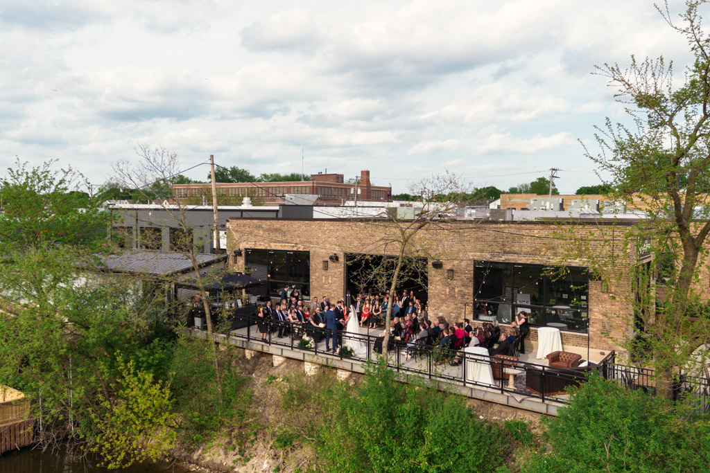 Wedding ceremony on the River Room at Burning Bush Brewery patio on a cloudy day