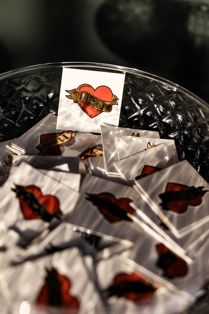 A bowl filled with heart-shaped temporary tattoos featuring a banner that reads 